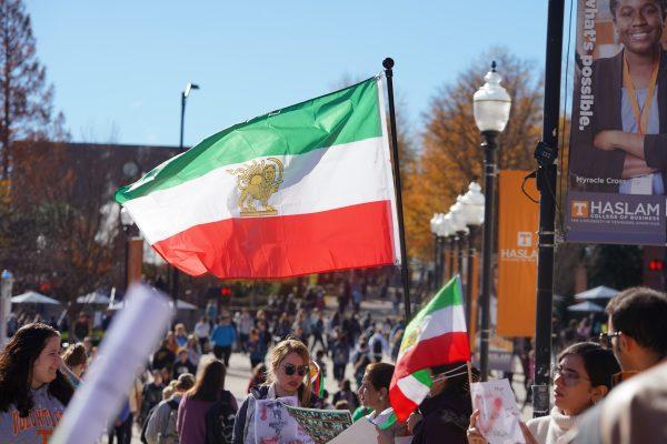 Participants in the Campus Rally for Iran wave the old Iranian flag on Ped Walkway to raise awareness of the Islamic Republic's deadly crackdown on protestors. 
