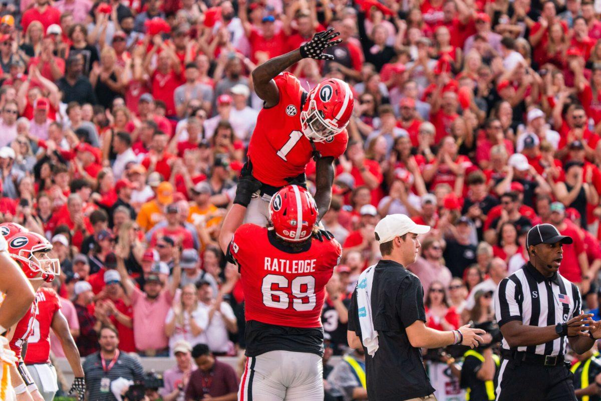 No. 1 Marcus Rosemy-Jacksaint celebrates with No. 69 Tate Ratledge after his touchdown reception in win over Tennessee on Nov. 4.