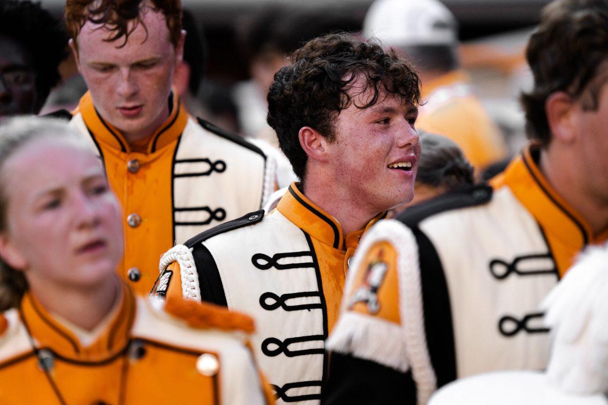 Members of the Pride of the Southland marching band walk off the field at the home game against Akron on Sept. 17, 2022.