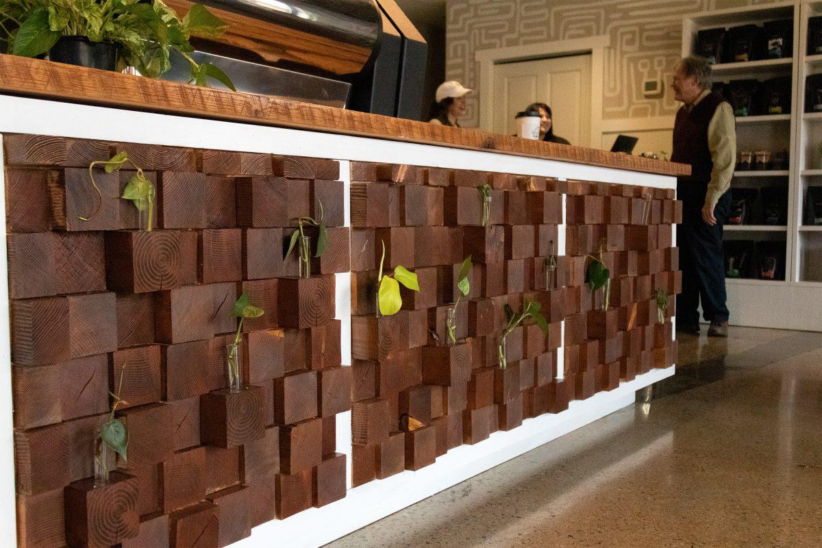 The Golden Roast's coffee bar features a display made from 537 blocks of wood and featuring plant propagations, constructed by general manager Taylor Renfro's husband.