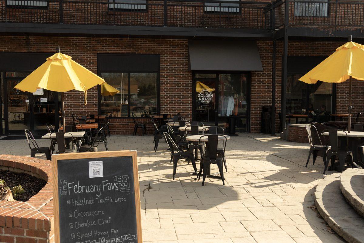 The patio at The Golden Roast's latest location welcomes customers with a list of featured drinks and a lots of outdoor seating.