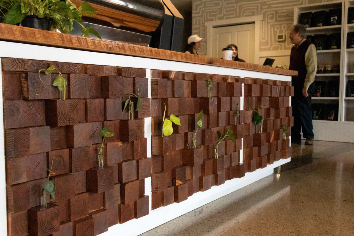 The Golden Roast's coffee bar features a display made from 537 blocks of wood and featuring plant propagations, constructed by general manager Taylor Renfro's husband.