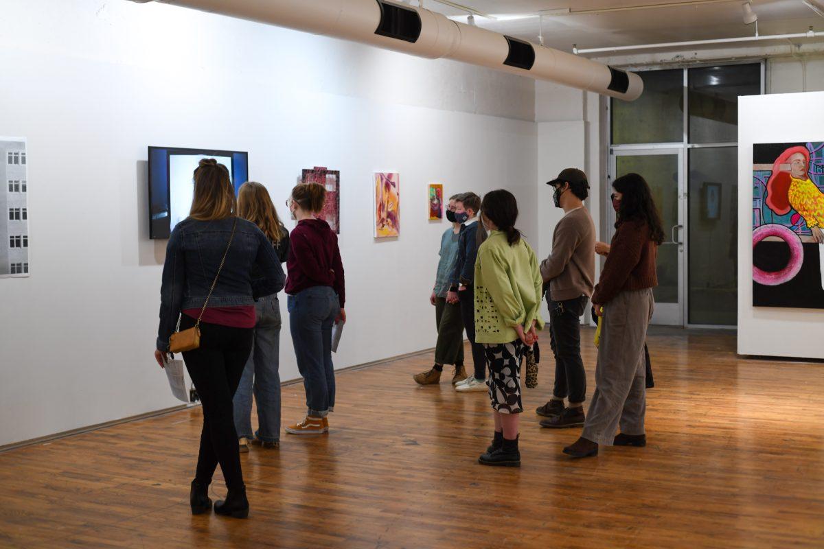 Issue 64 gallery attendees silently observe the shadow puppetry short film, "Volume I", by Faith Belt, included in Phoenix Magazine's Issue 64 on display at Gallery 1010. Thursday, Feb. 17 2022.