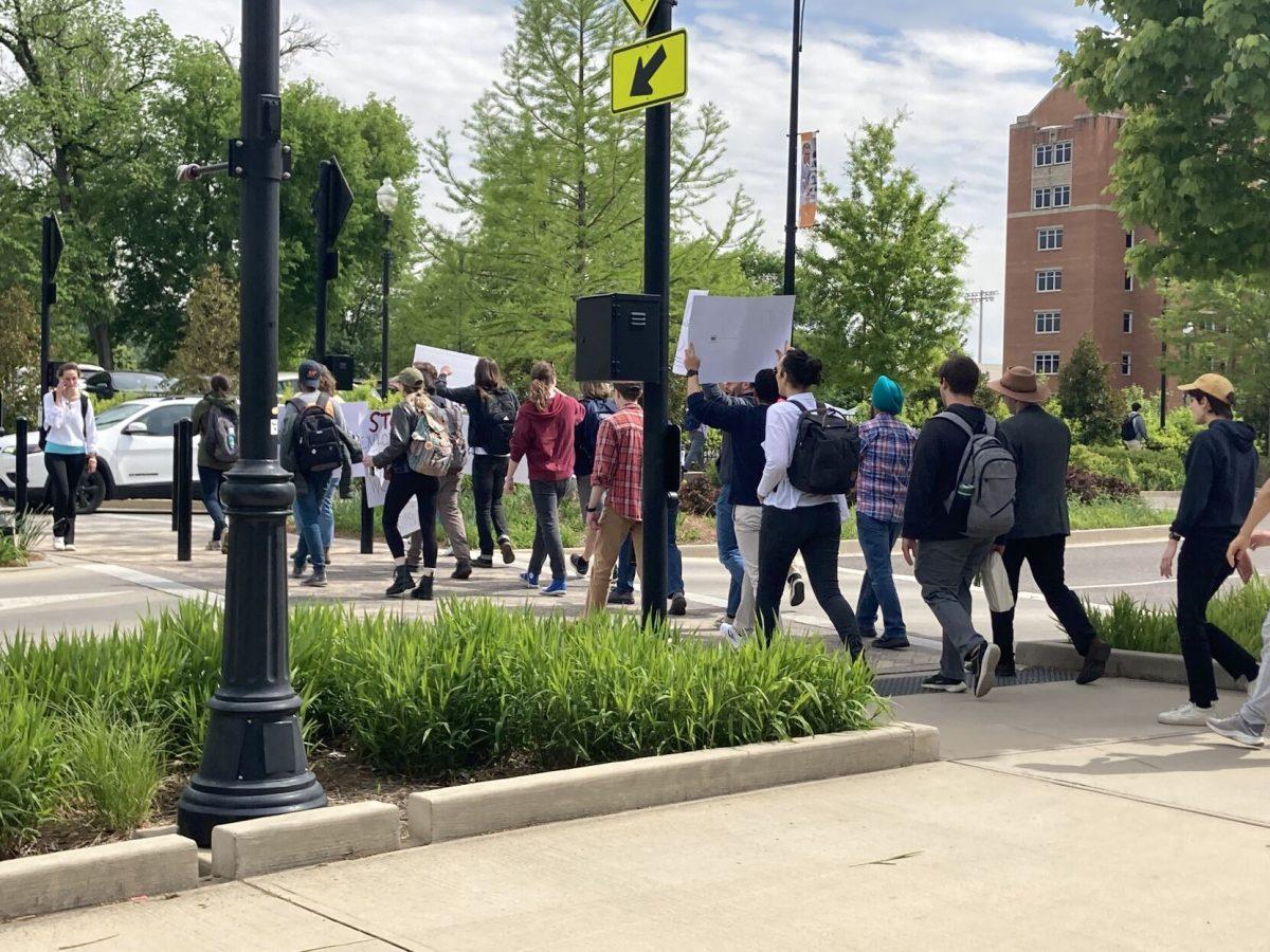 Graduate students, staff and faculty march towards the office of Chancellor Donde Plowman in Andy Holt Tower to present a petition for higher base stipends for graduate assistants. 