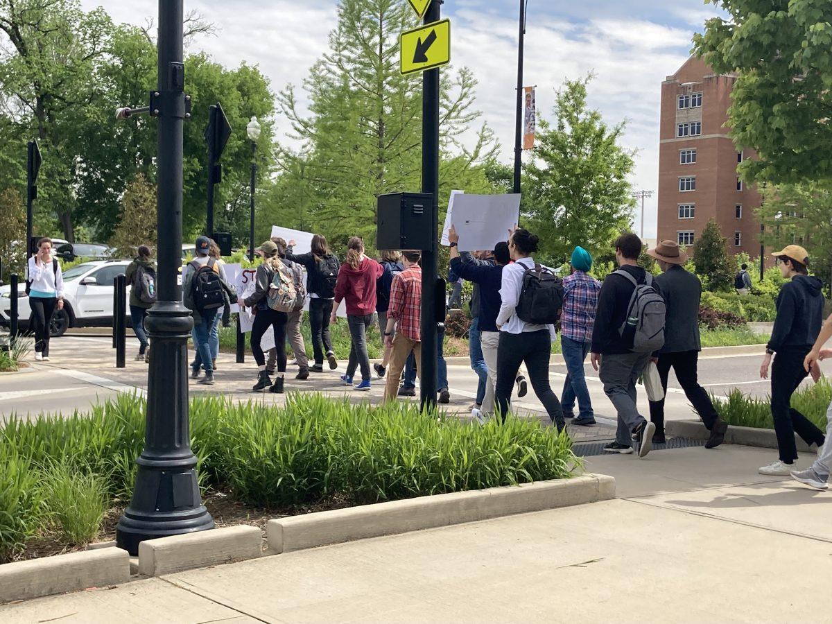Graduate students, staff and faculty march towards the office of Chancellor Donde Plowman in Andy Holt Tower to present a petition for higher base stipends for graduate assistants. 