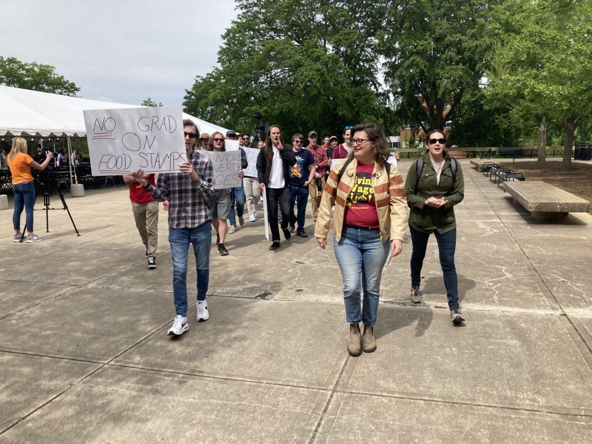 Graduate students, staff and faculty gather in McClung Plaza to petition for higher pay for graduate assistants. 