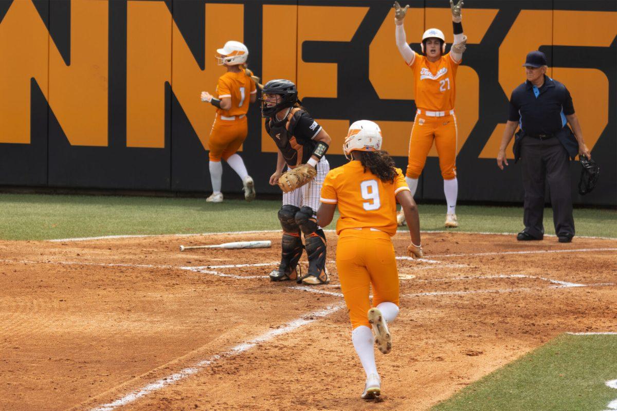 Guilia Koutsoyanopulos (27) waives teammate Kiki Milloy (9) home after a triple by Lair Beautae against Mercer. Thursday April 6, 2023.