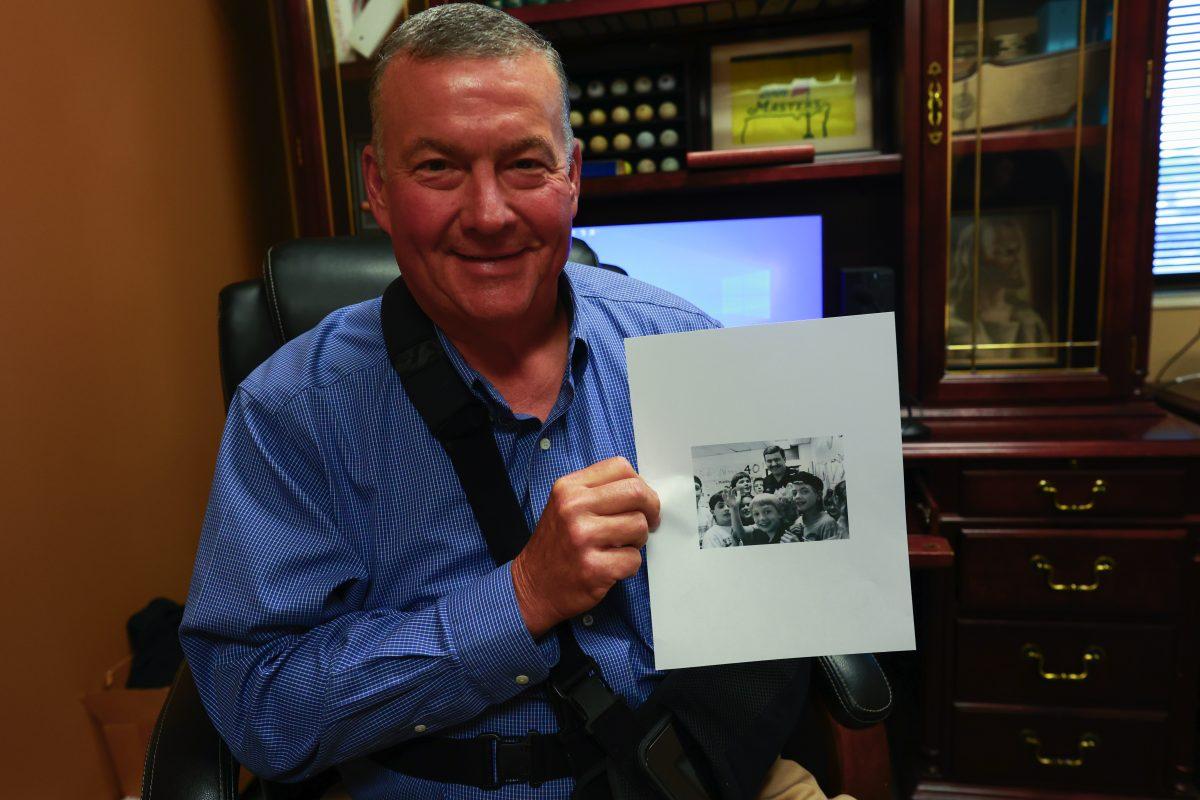 Circuit Court Clerk Bobby Vann holds up a photo of himself from the very first issue of Eyes on Lafollette from 30 years ago in 1993. Photo by Ericksen Gomez-Villeda