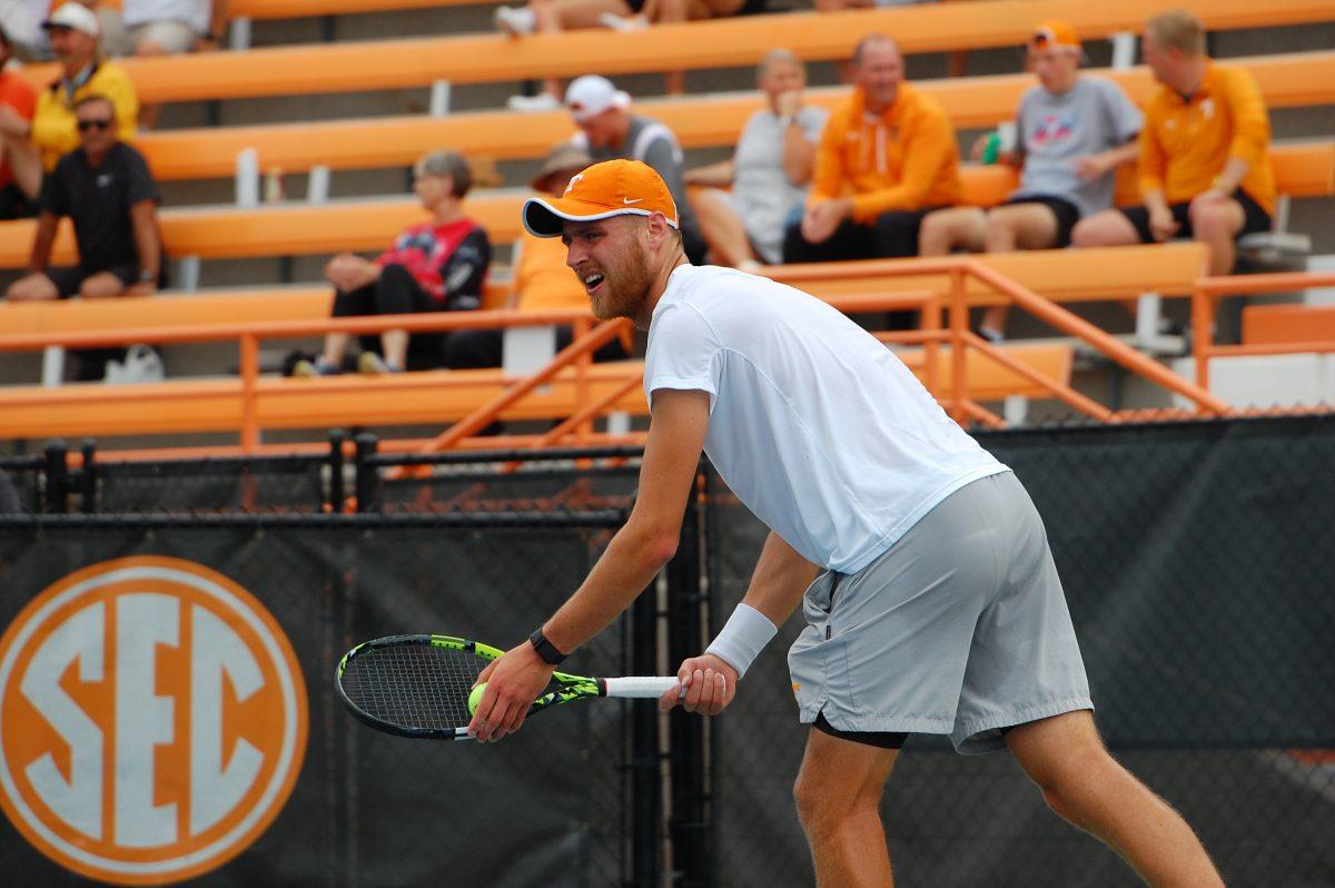 Emile Hudd readies for serve in a win over Belmont in the first round of the NCAA Tournament on May 6, 2023.