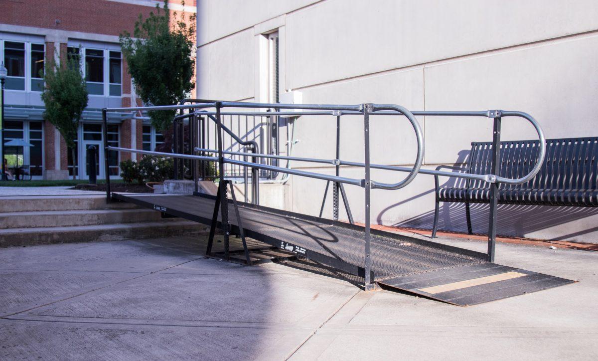 A makeshift wheelchair accessible ramp next to the Haslam Business Building and the Student Center.