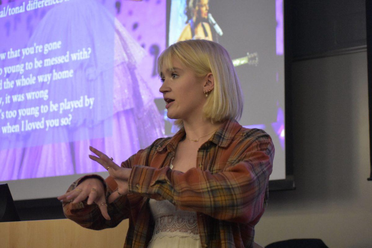 Senior English major and student assistant Laura Snyder discusses lyrics from Taylor Swift's "Dear John" at the first Taylor Swift Literary Club meeting on Sept. 14, 2023.