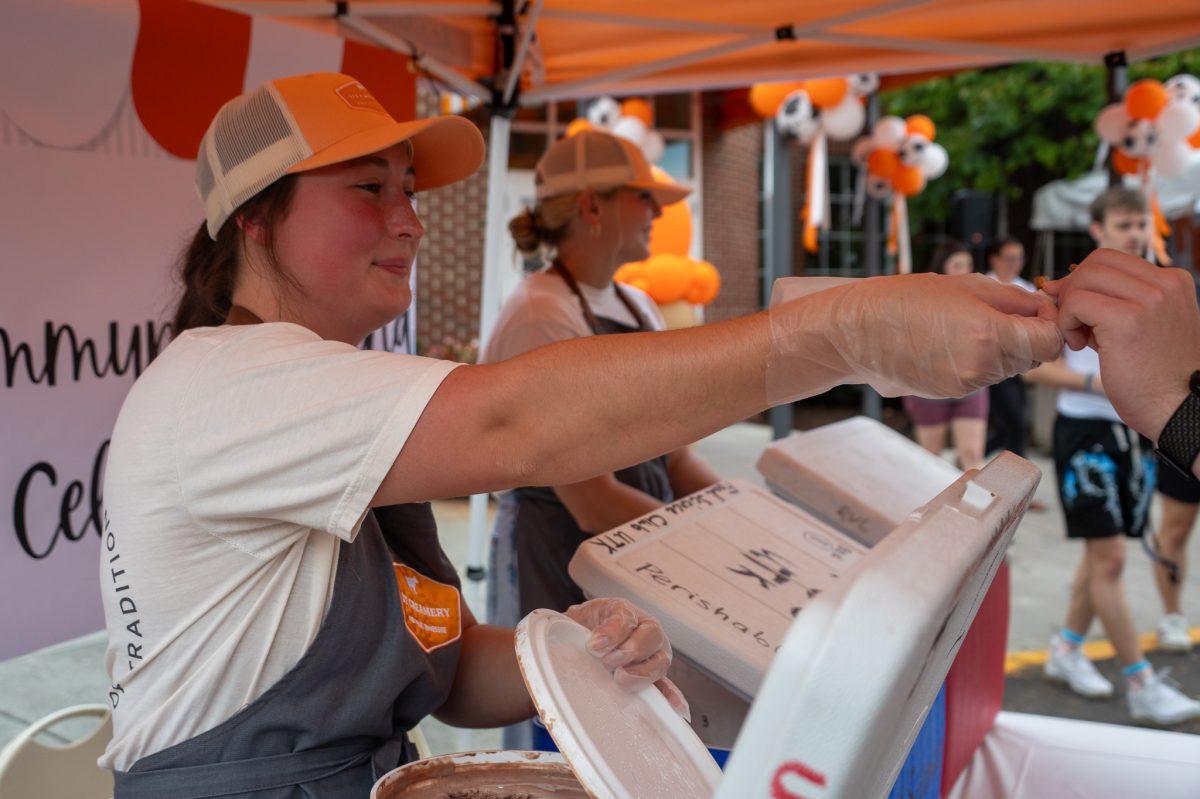 Students working at the UT Creamery hand out free ice cream samples to attendees of the creamery's official ribbon cutting ceremony. Tuesday, Sept. 12, 2023.