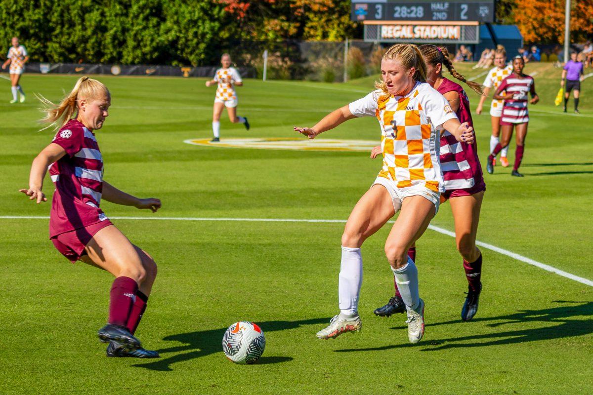 Sizzy Lawton (3) keeps the ball away from two Texas A&amp;M defenders as she approaches A&amp;M's goal at Regal Soccer Stadium. Sunday, Oct. 22, 2023.