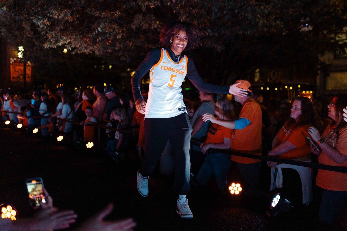 Kaiya Wynn (5) high fives fans at Market Square Madness in downtown Knoxville. Knoxville, TN. Thursday, Oct. 12, 2023.