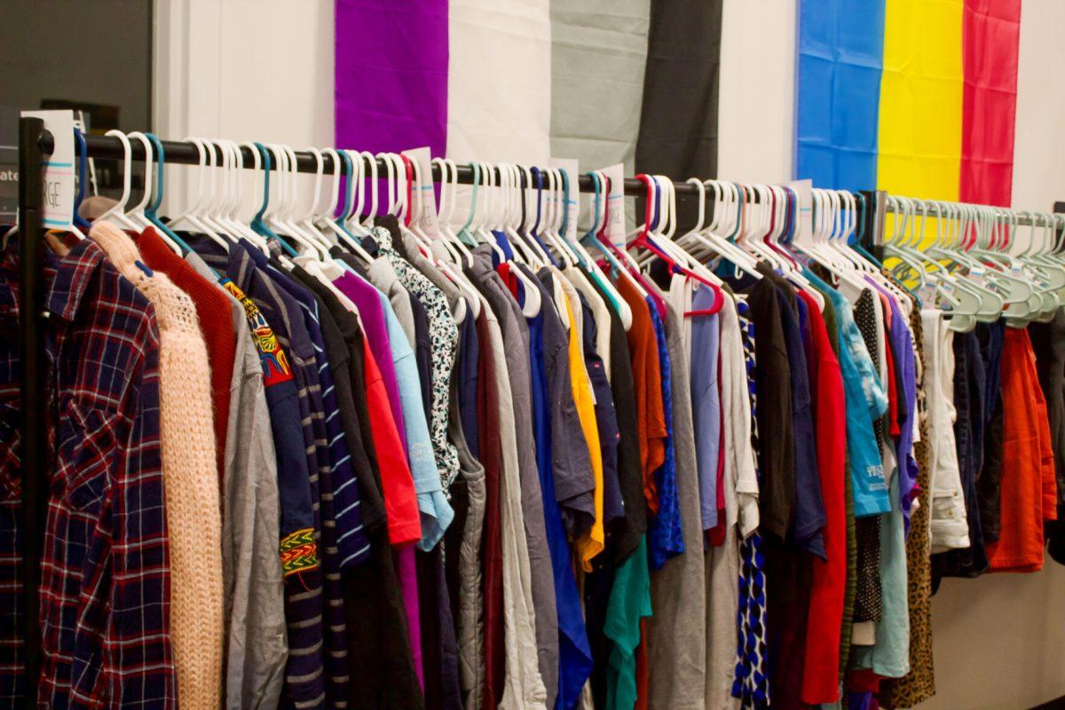 A rack of clothes labeled simple by size instead of gender sits on display in the Pride Center. Wednesday, Oct. 11, 2023.