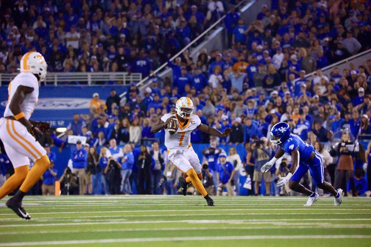 Joe Milton III (7) stiff-arms a defender during a game against Kentucky at Kroger Field. Oct. 28, 2023.