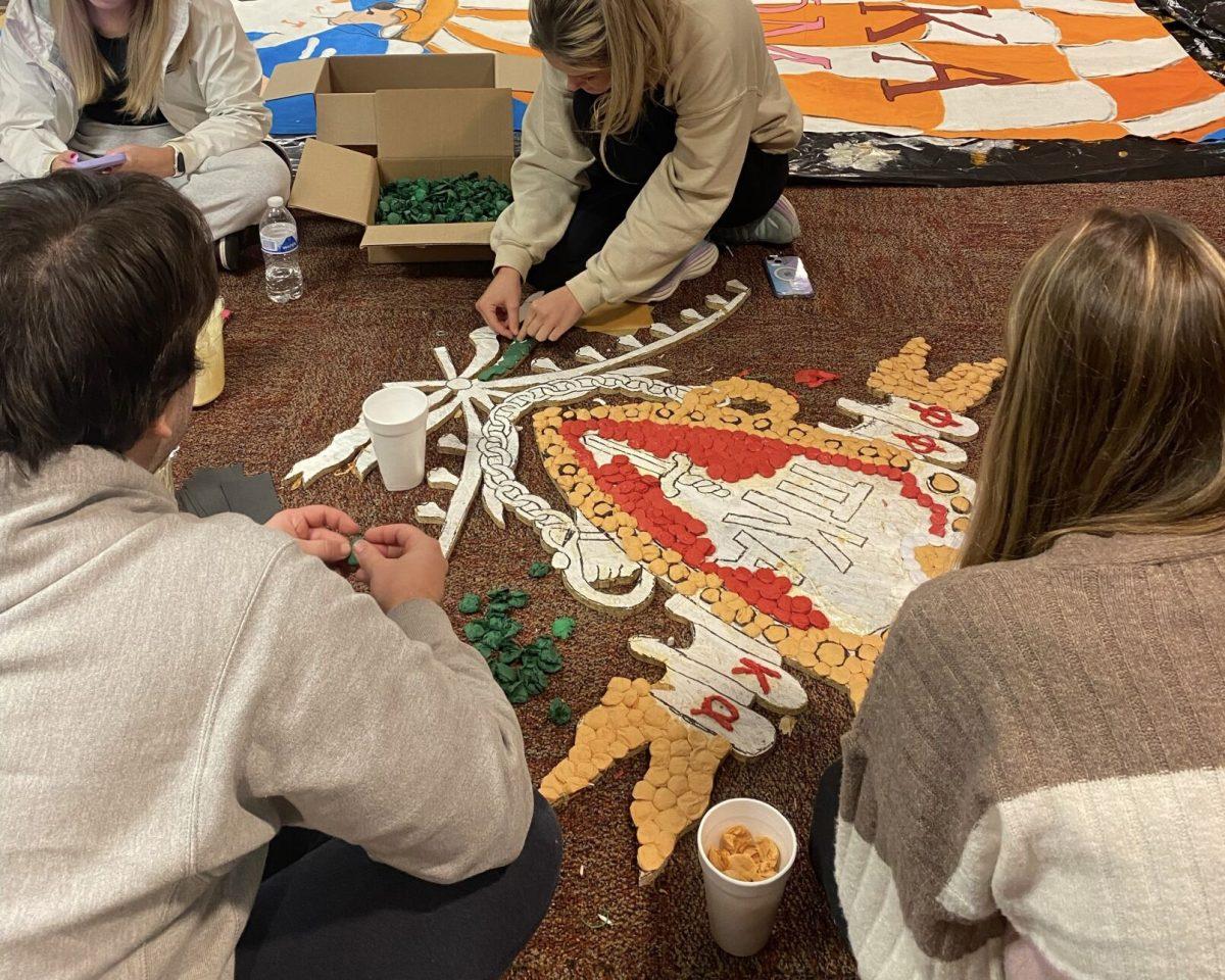 Members of UT's Phi Mu and Pi Kappa Alpha chapters spend hours pomping their Homecoming float. Oct. 30, 2023. 