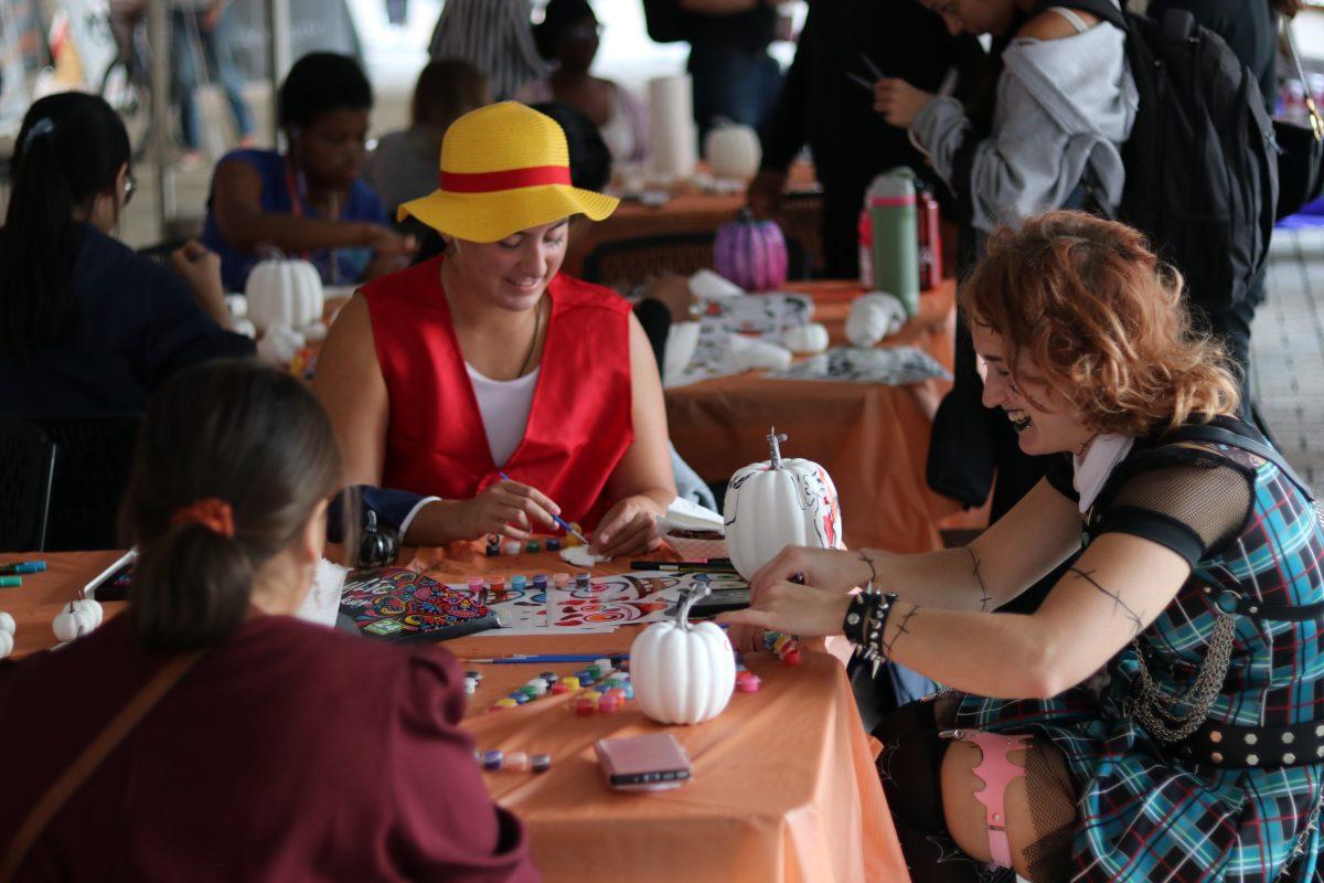 Students paint pumpkins at UT's Haunted Campus. 