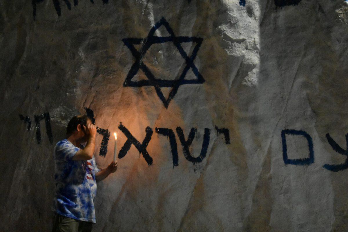 A student takes a moment to honor those who passed in the recent Hamas attack. Thursday, Oct. 12, 2023.