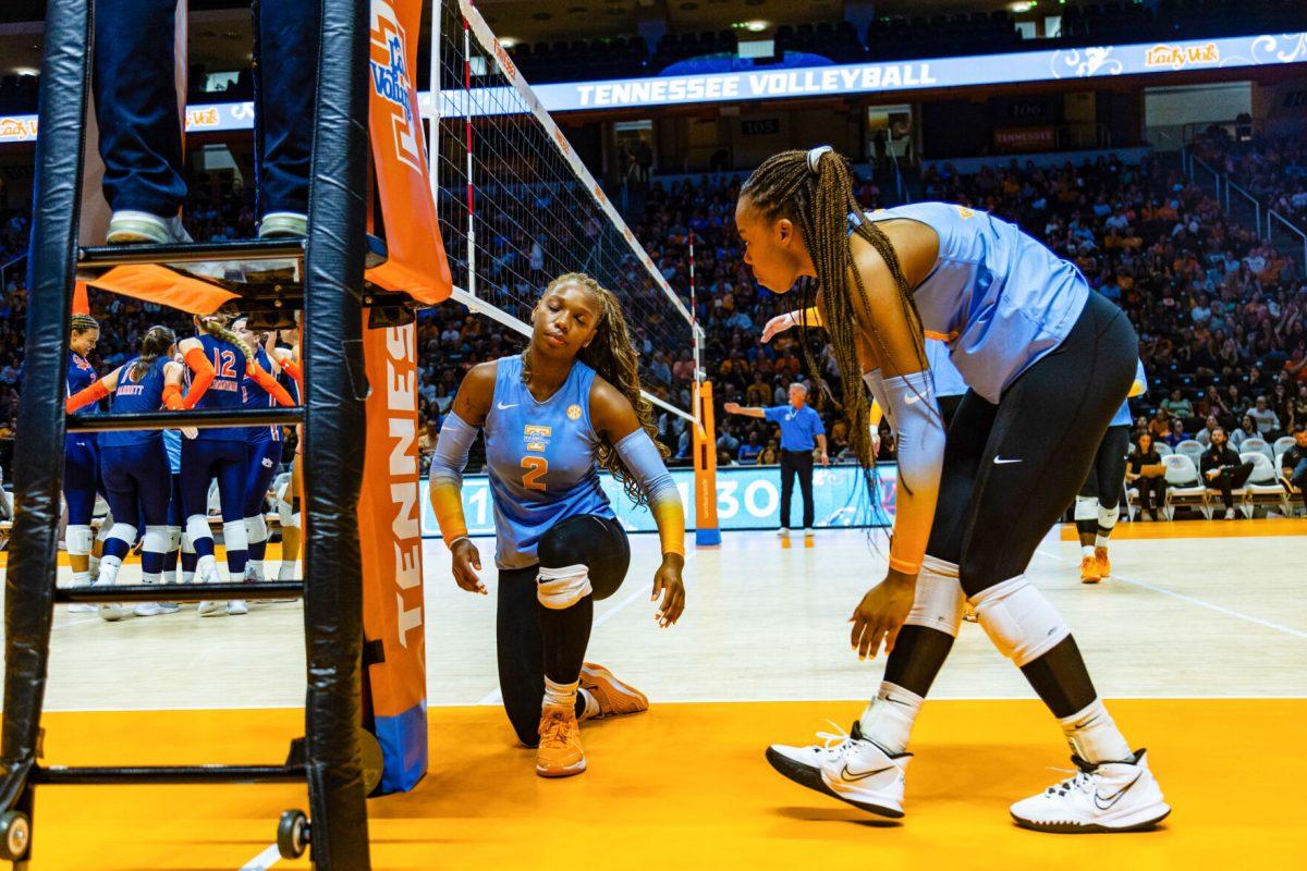 Erykah Lovett (2) is helped up by her teammates as they fall in the second set. Friday, Oct. 13, 2023. 