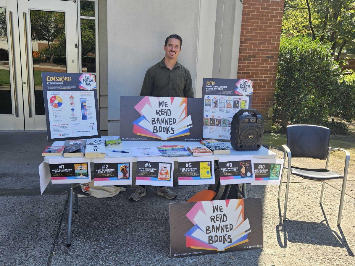 Graduate student Blake Trent participates in the English department's Banned Book Weeks readings outside the Claxton Education Building. Oct. 4, 2023.