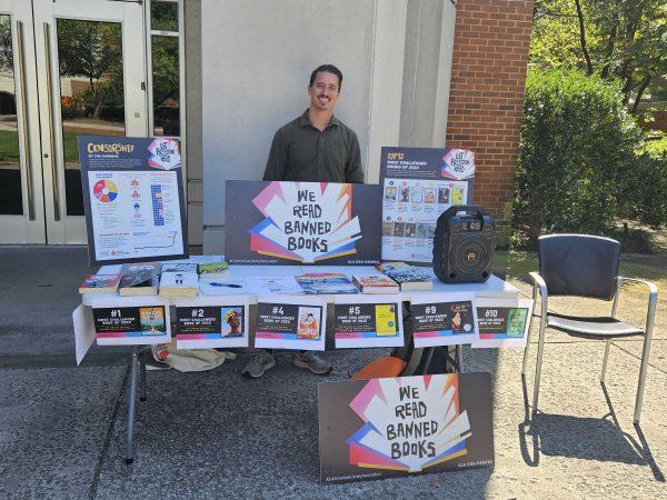 Graduate student Blake Trent participates in the English department's Banned Book Weeks readings outside the Claxton Education Building. Oct. 4, 2023.