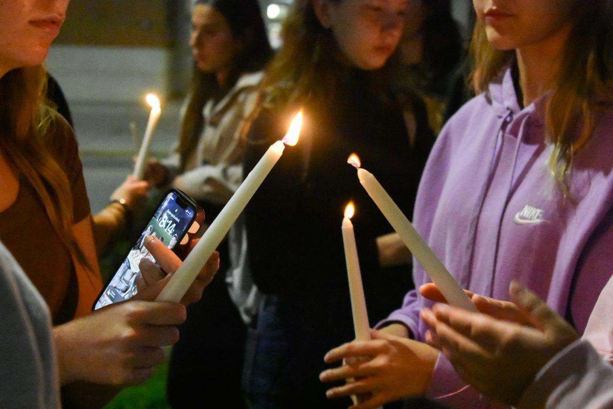 Students come together to light each other's candles in memoriam of those lost in the Hamas attack. Thursday, Oct. 12, 2023. 