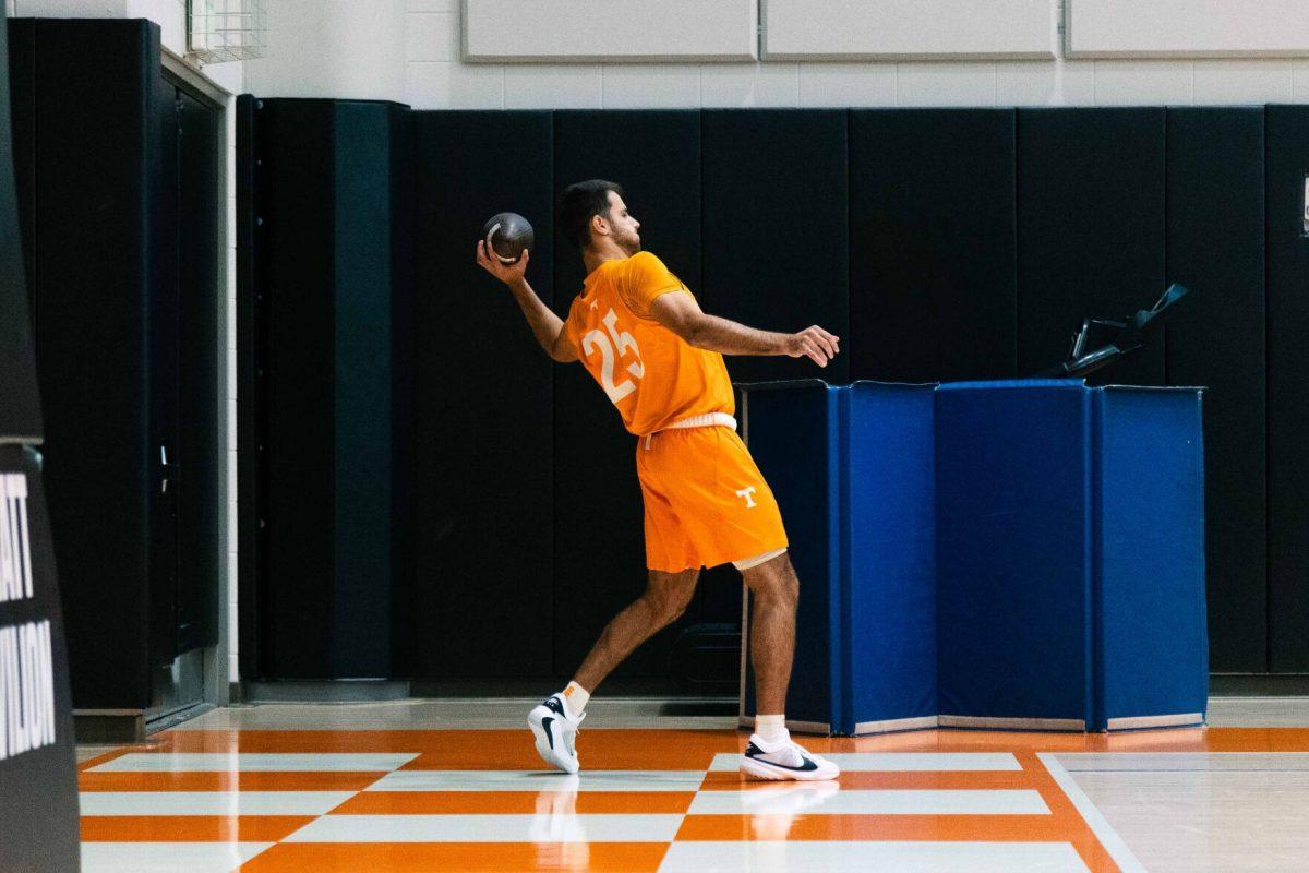 Santiago Vescovi (25) throws a football before practice in Pratt Pavilion. Thursday, Nov. 2, 2023.  