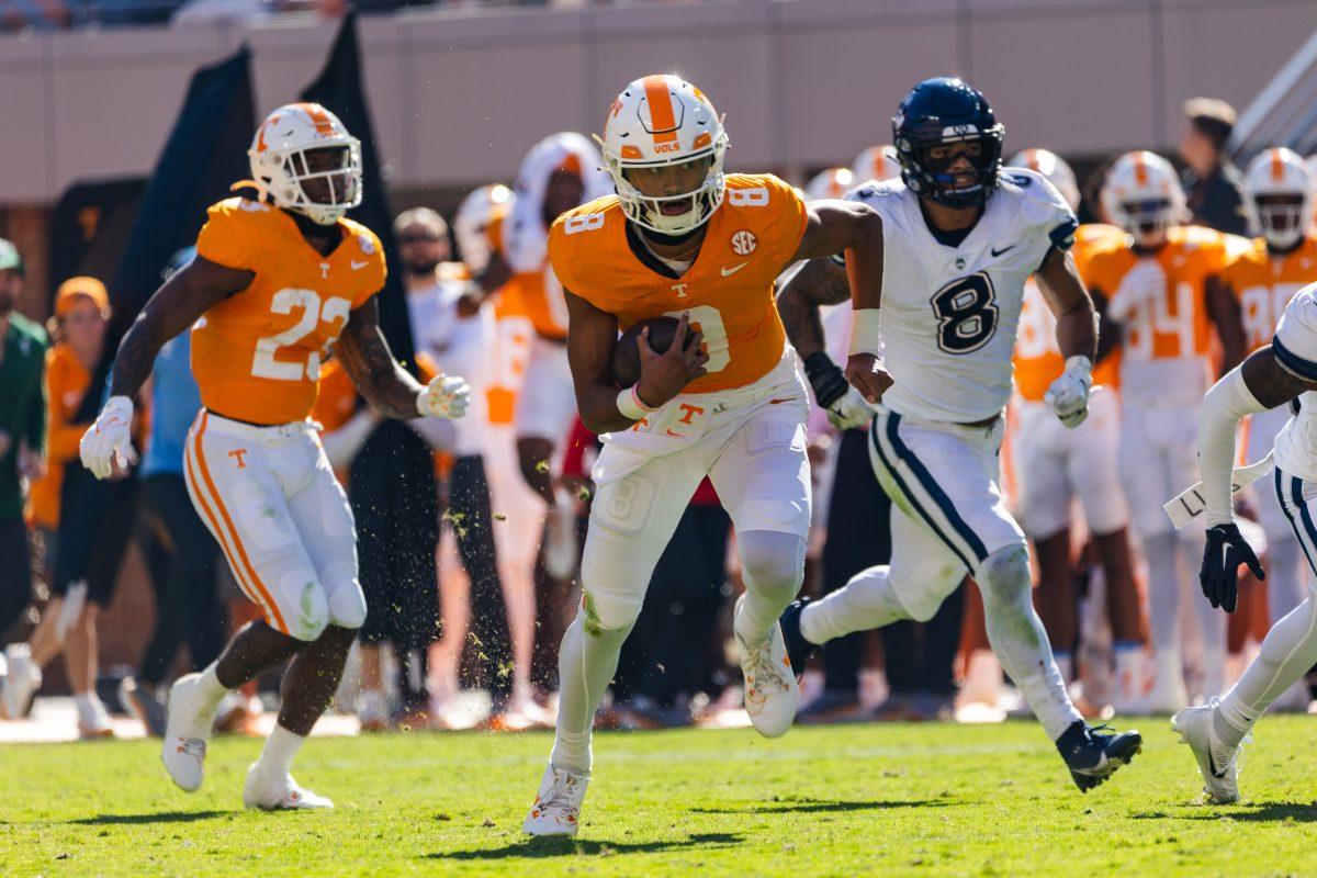 Freshman quarterback Nico Iamaleava (8) jukes a UConn defender to gather a first down. Saturday, Nov. 4, 2023.
