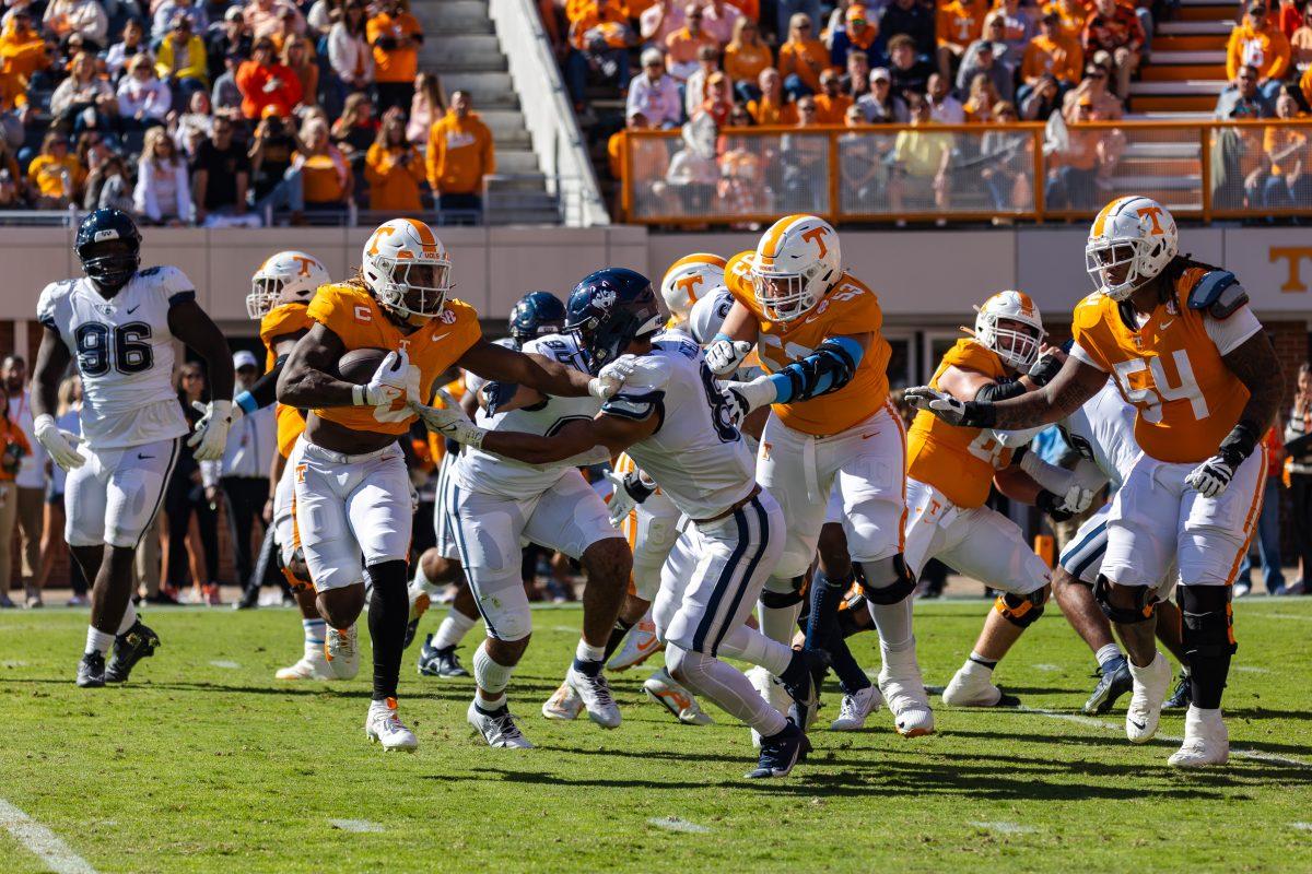 Jaylen Wright (0) stiff-arms a UConn defender as the Volunteers approach the end zone to score their second touchdown. Saturday, Nov. 4, 2023.