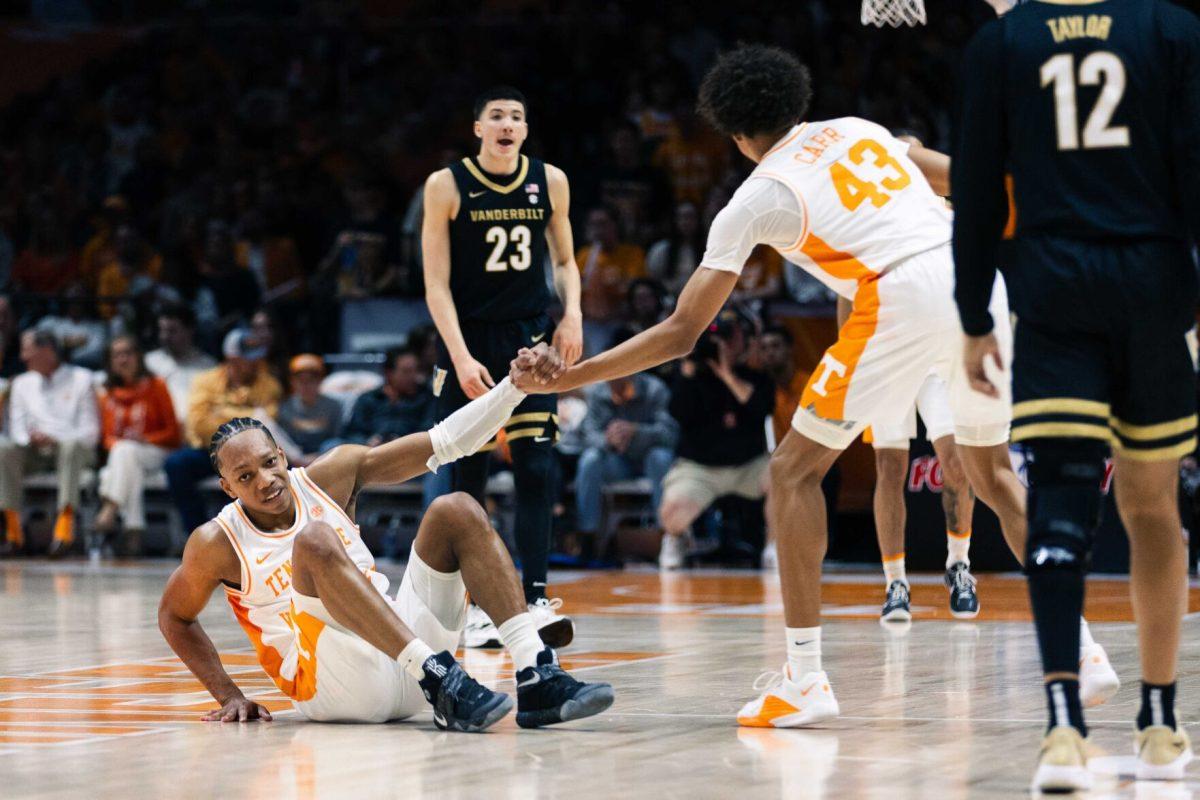 Jordan Gainey (2) is helped up by teammate Cameron Carr (43) against Vanderbilt at the Food City Center. Saturday, Feb. 17, 2024.