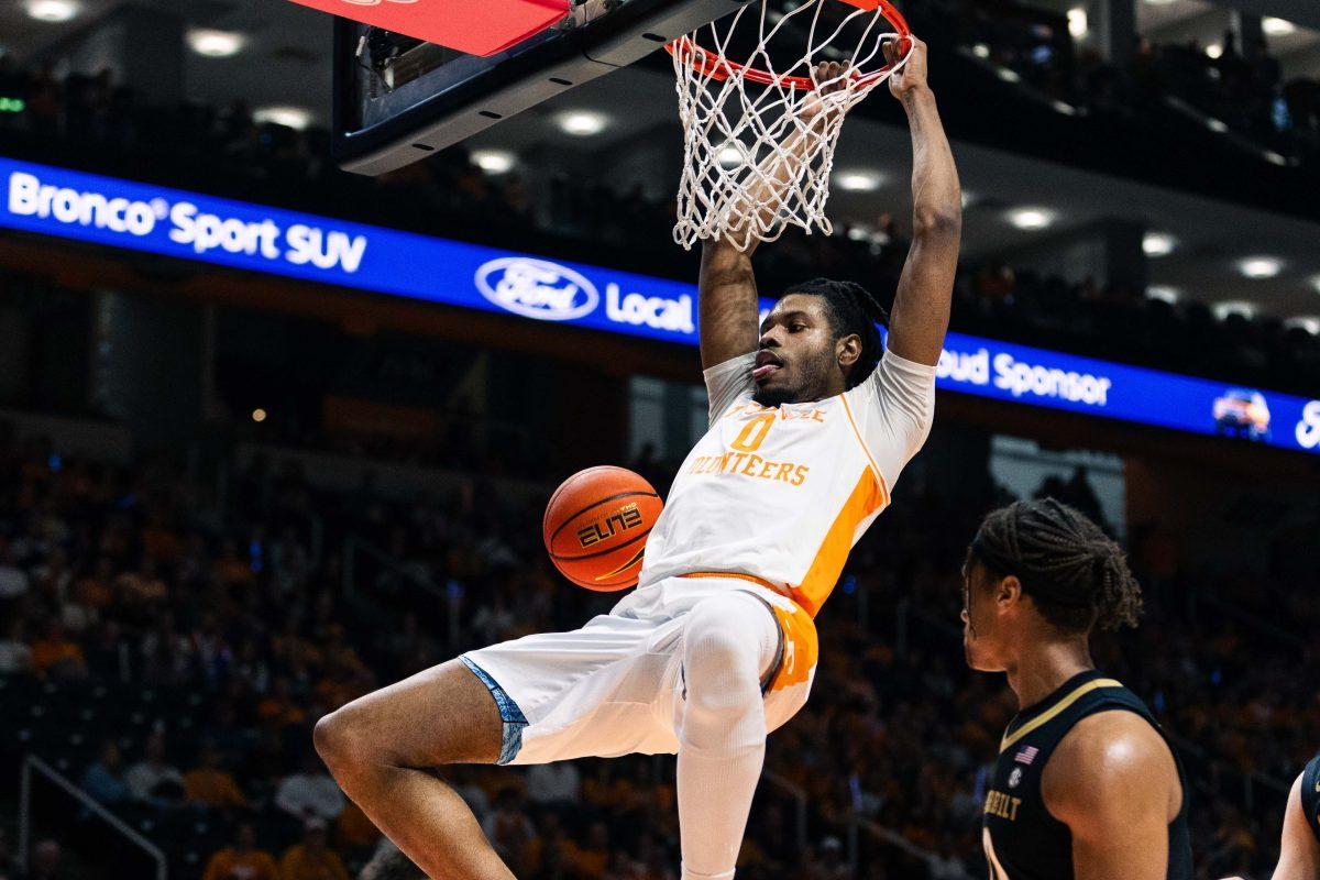 Jonas Aidoo (0) swings on the rim after a dunk against Vanderbilt at the Food City Center. Saturday, Feb. 17, 2024