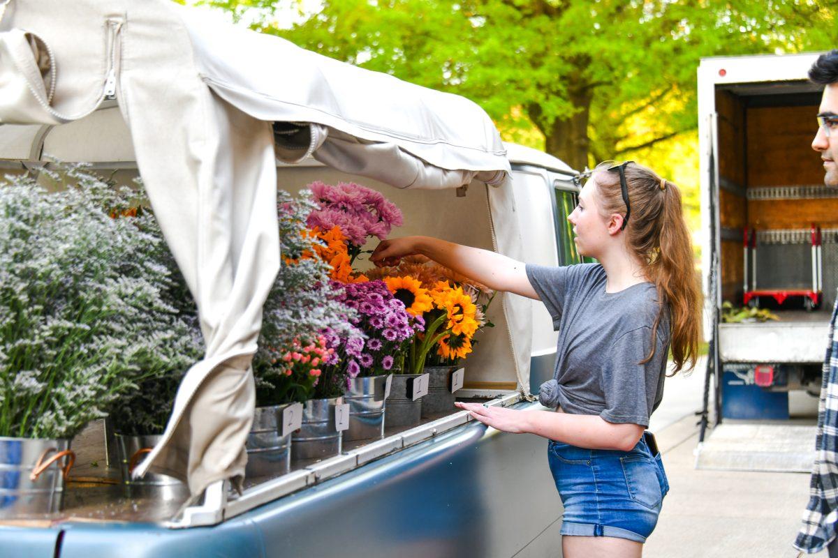 Students help themselves to free plants during the Earth Day Festival at the HSS Plaza on Friday, April 22, 2022.