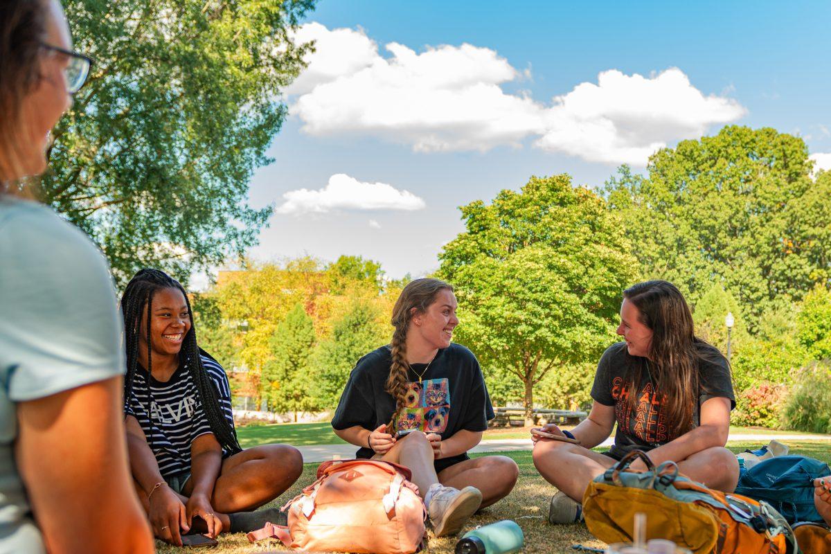 Eden Allen (right), Sara Alexander (middle), Taia Sorrell (left) and their friends sit on HSS lawn and share their life experiences at a Chi Alpha meeting.
