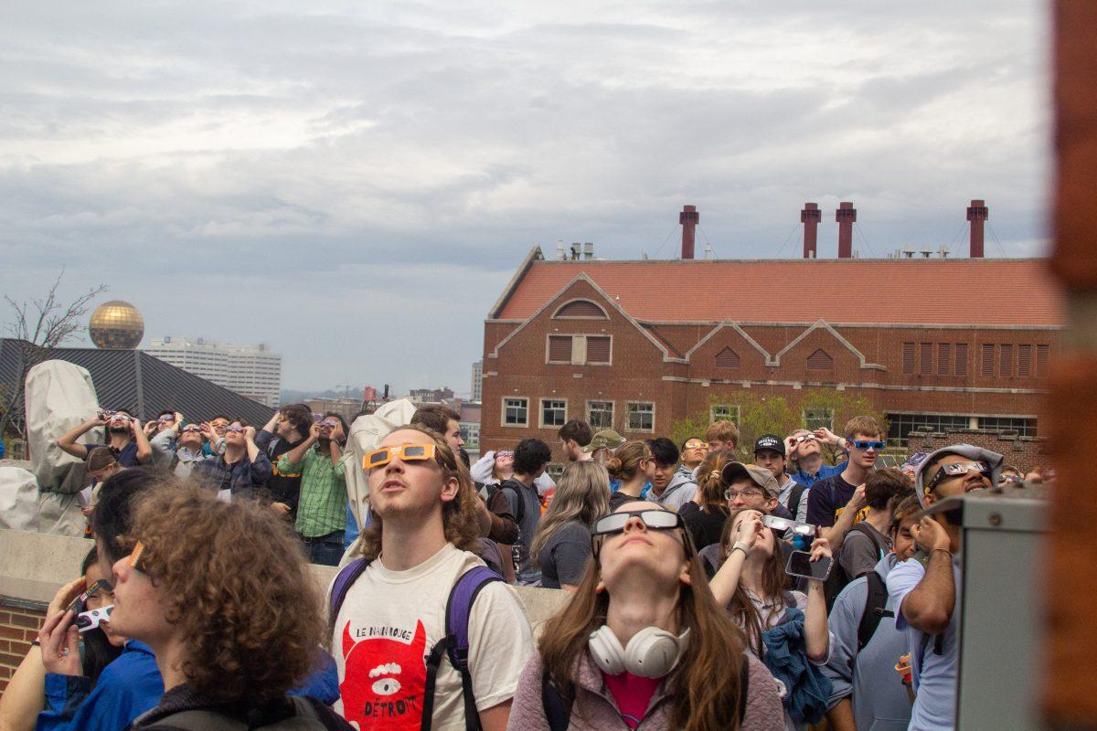 Students stare up at a solar eclipse near Ayres Hall. Monday, April 8, 2024. 