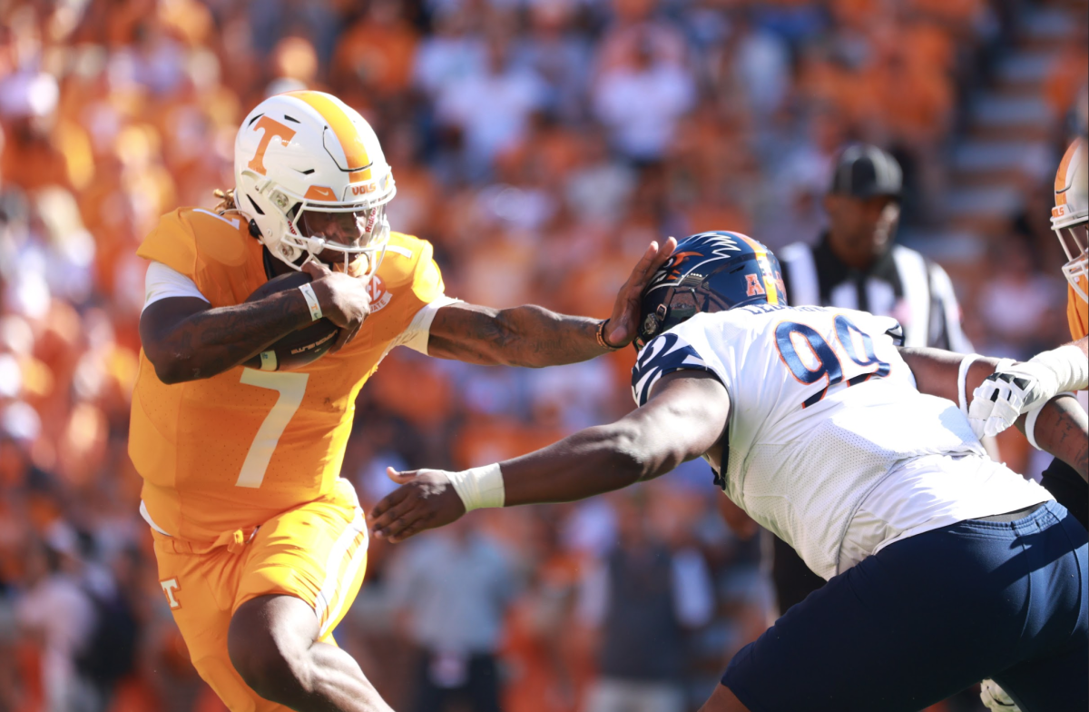 Joe Milton III (7) stiff arms a UTSA defender in Neyland Stadium. Saturday, Sept. 23, 2023. 