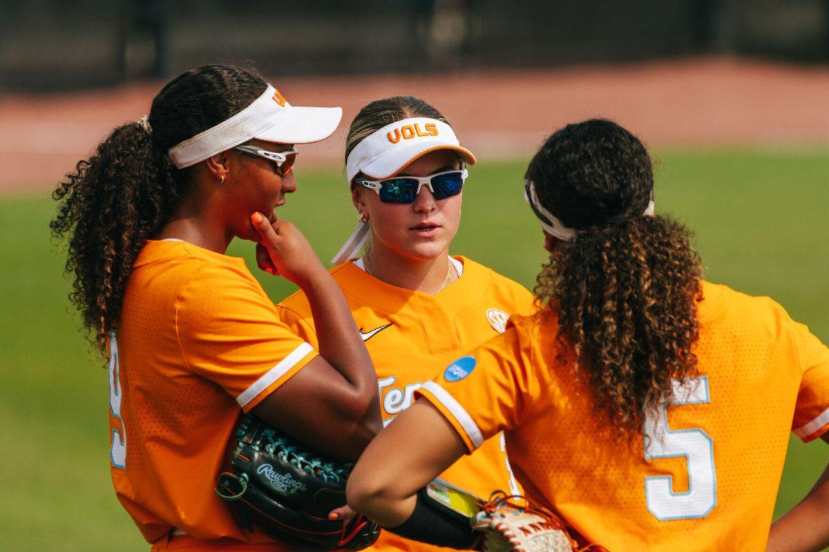 Lady Vols outfield meet during a game against Alabama at Sherri Parker Lee Stadium. Friday, May 24, 2024.