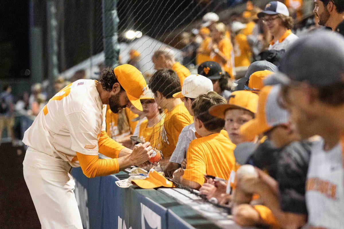 Tony Vitello signs memorabilia for young fans at Lindsey Nelson Stadium. Sunday, June 2, 2024.