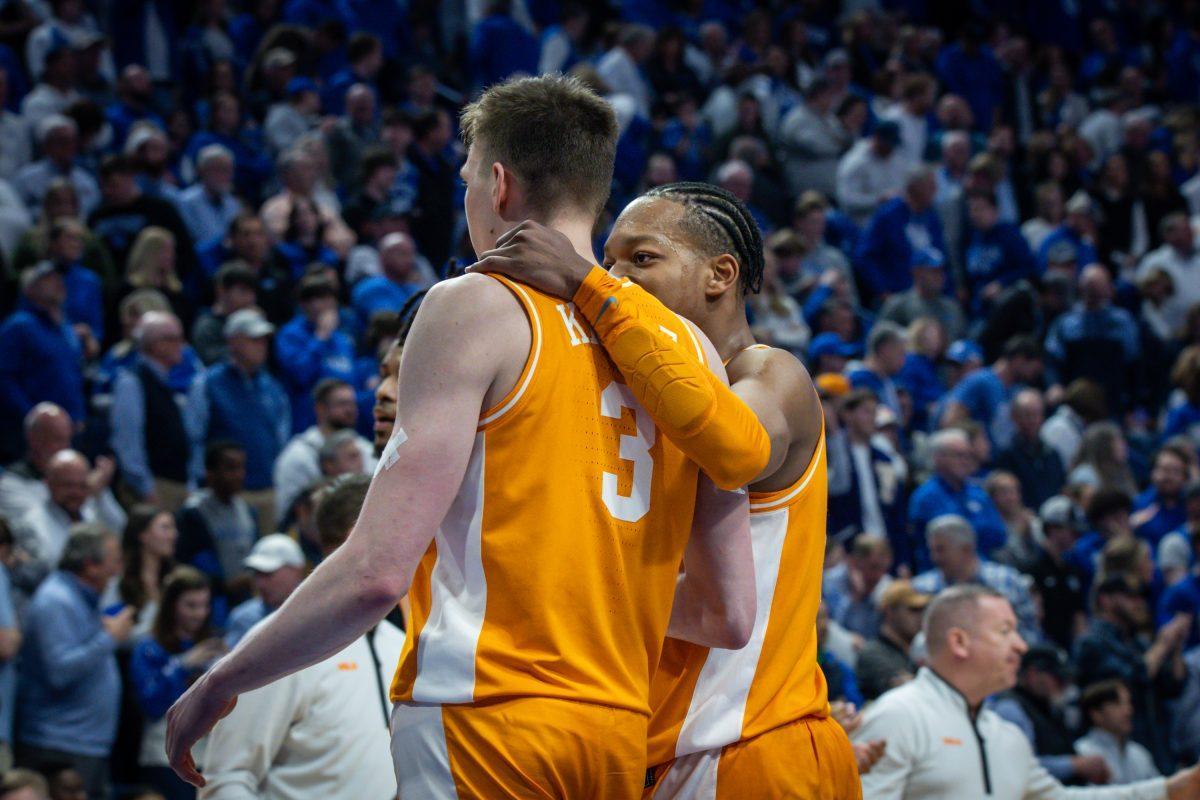 Dalton Knecht (3) and Jordan Gainey (2) celebrate a victory over Kentucky at Rupp Arena. Saturday, Feb. 3, 2024.