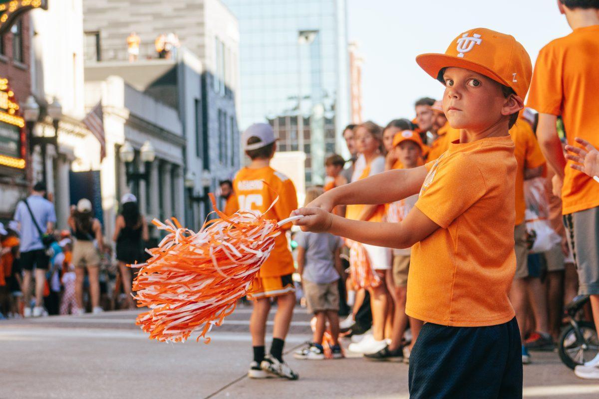 Young Volunteer Fan practices his swing before the National Champion Volunteers parade. Tuesday, June 25, 2024.