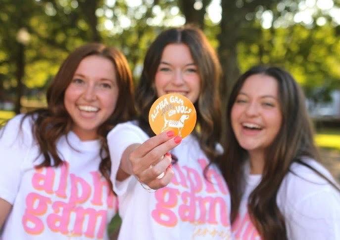 Members of the Alpha Gam Leadership team holding a Vols gameday pin.