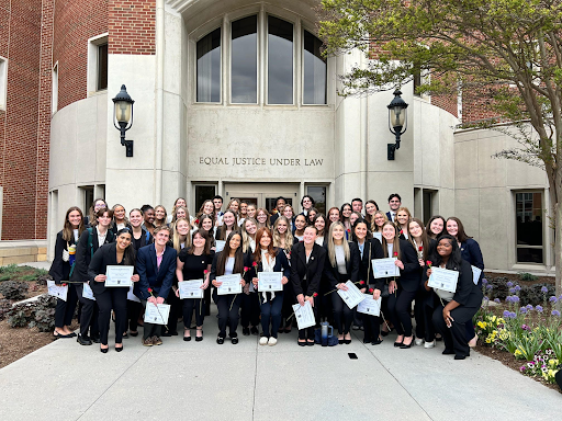 Alpha Kappa Pi fraternity posed for a group photo outside the College of Law. 