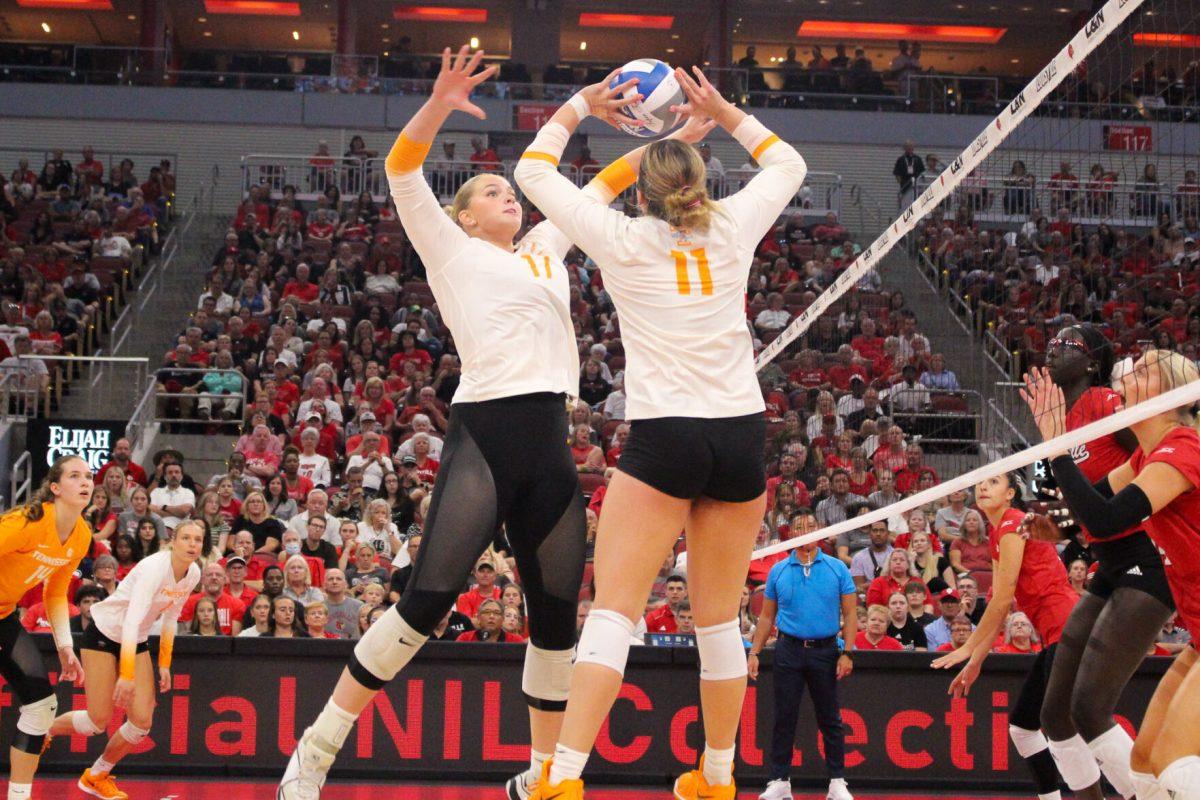 Caroline Kerr (11) sets to Emily Beeker (17) during a match against Louisville at the KFC Yum! Center. Sunday, Sept. 1, 2024.