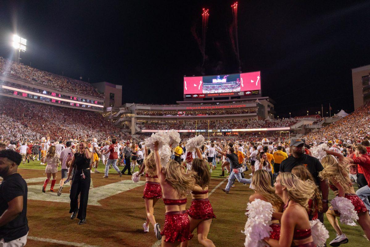 Arkansas fans storm the field after defeating Tennessee at Donald W. Reynolds Razorback Stadium. Saturday, Oct. 5, 2024. 