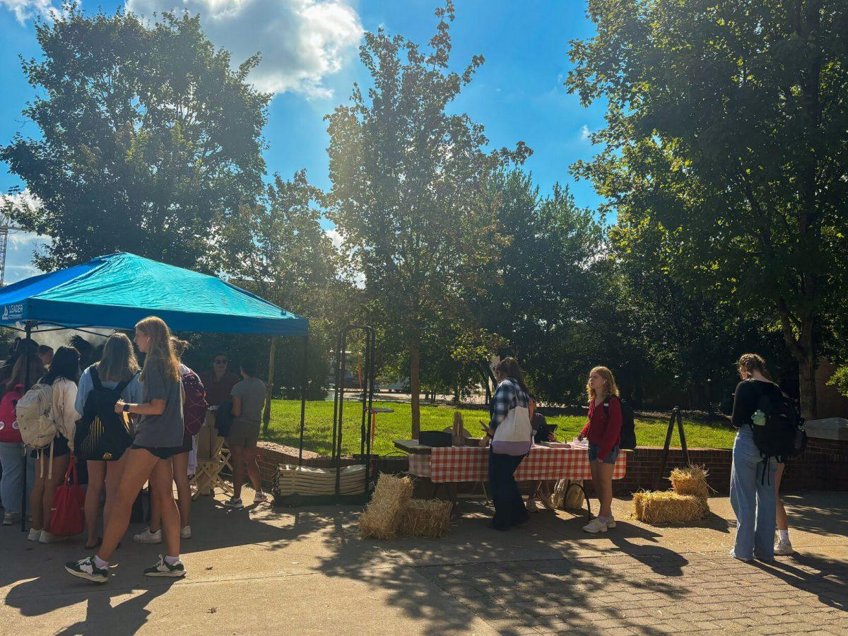 Students shop around different booths on Ped Walkway during the Fall Harvest Market. Wednesday, Oct. 2, 2024.
 