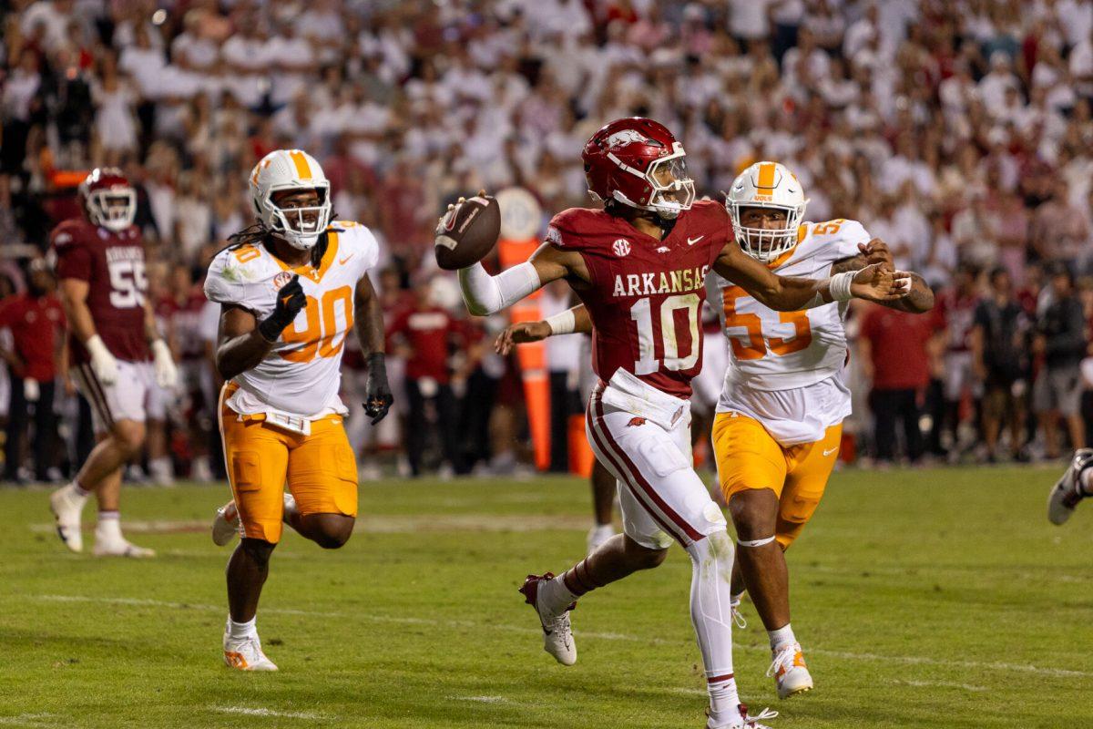 Taylen Green (10) of Arkansas is chased by two Tennessee defenders during a game against Arkansas at Donald W. Reynolds Razorback Stadium. Saturday, Oct. 5, 2024. 