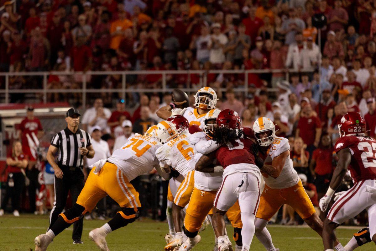 Nico Iamaleava (8) is hit as he throws during a game against Arkansas at Donald W. Reynolds Razorback Stadium. Saturday, Oct. 5, 2024. 