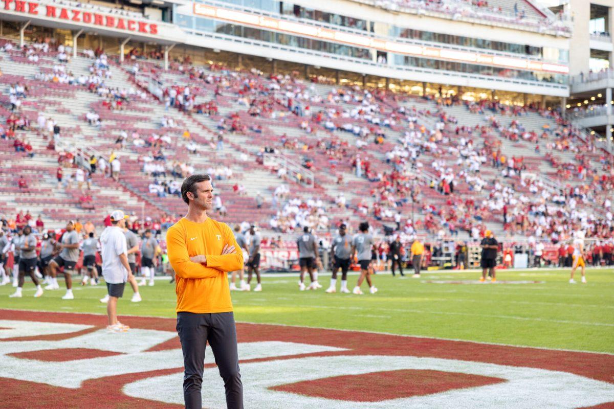 Tennessee offensive coordinator Joey Halzle watches his team warm up before a game against Arkansas at Donald W. Reynolds Razorback Stadium. Saturday, Oct. 5, 2024. 
 