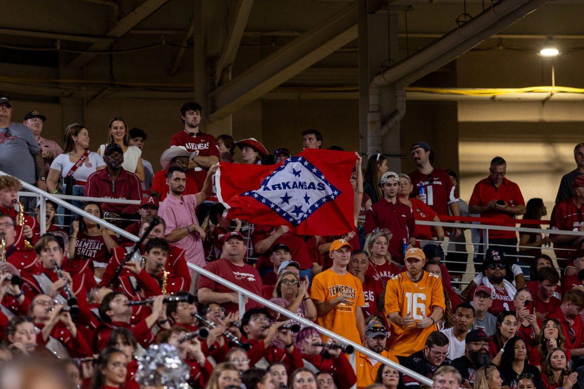 Fans hold an Arkansas flag during a game against Arkansas at Donald W. Reynolds Razorback Stadium. Saturday, Oct. 5, 2024. 