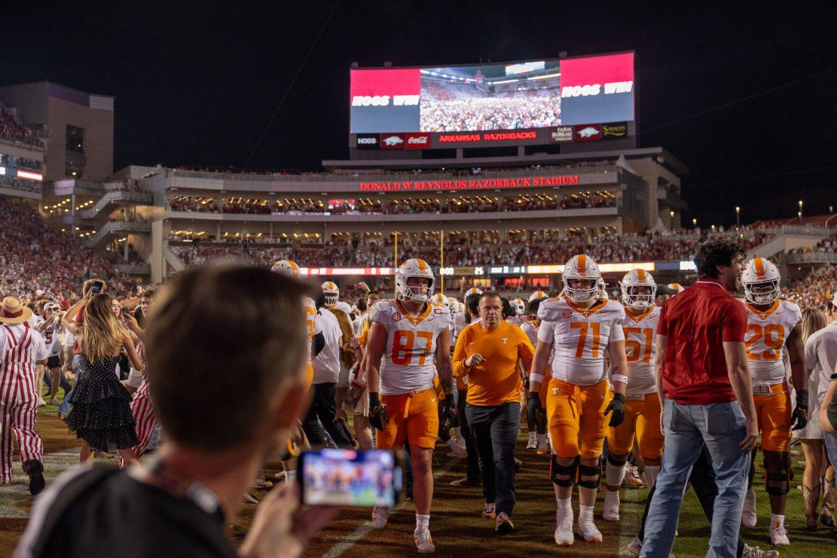 Tennessee players exit the field as Arkansas fans run on after losing to Arkansas at Donald W. Reynolds Razorback Stadium. Saturday, Oct. 5, 2024. 